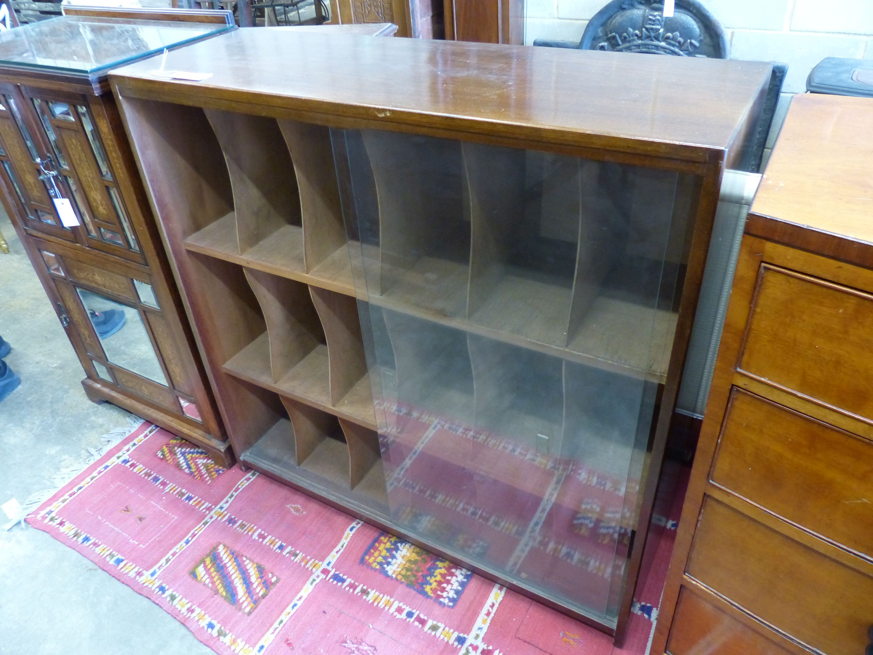 A mid century glazed teak eighteen section record cabinet, length 104cm, depth 35cm, height 104cm